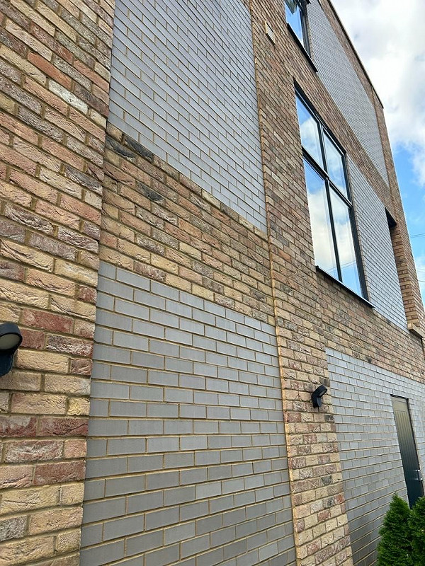 A mix of smooth grey bricks and textured buff brickwork.