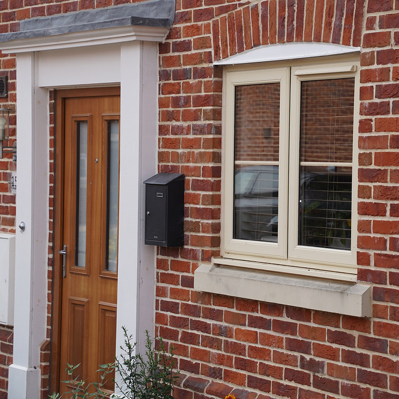 Portland Stone window cill on a red multi brick.