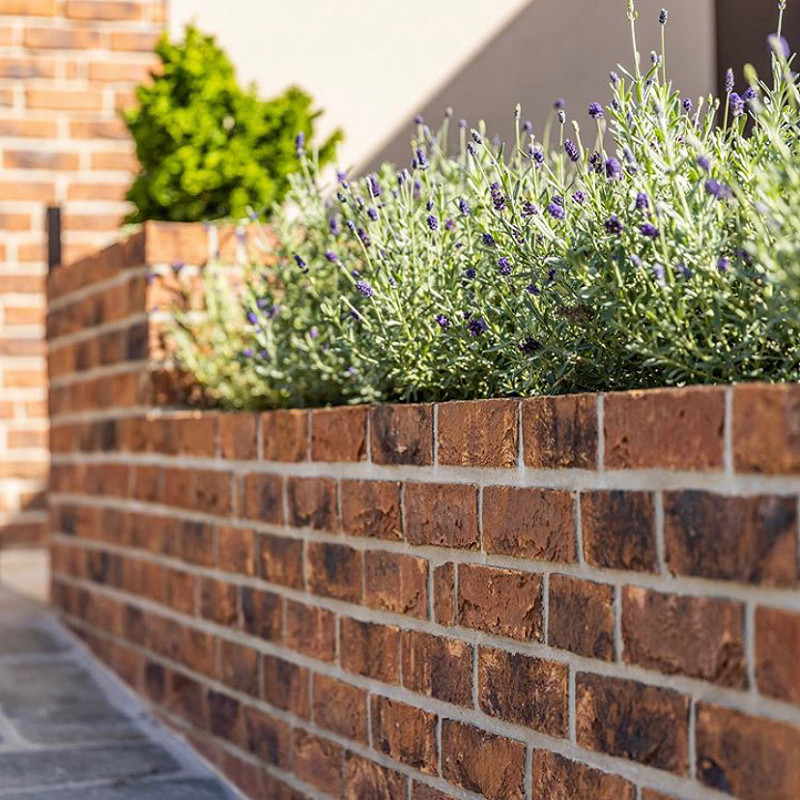 boundary wall constructed in a Copper Red Multi brick.