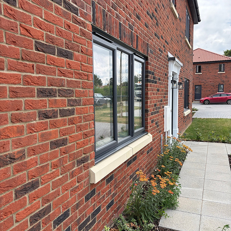 Close up showing the Knebworth Red Multi brick with cast stone cills and brick arches.