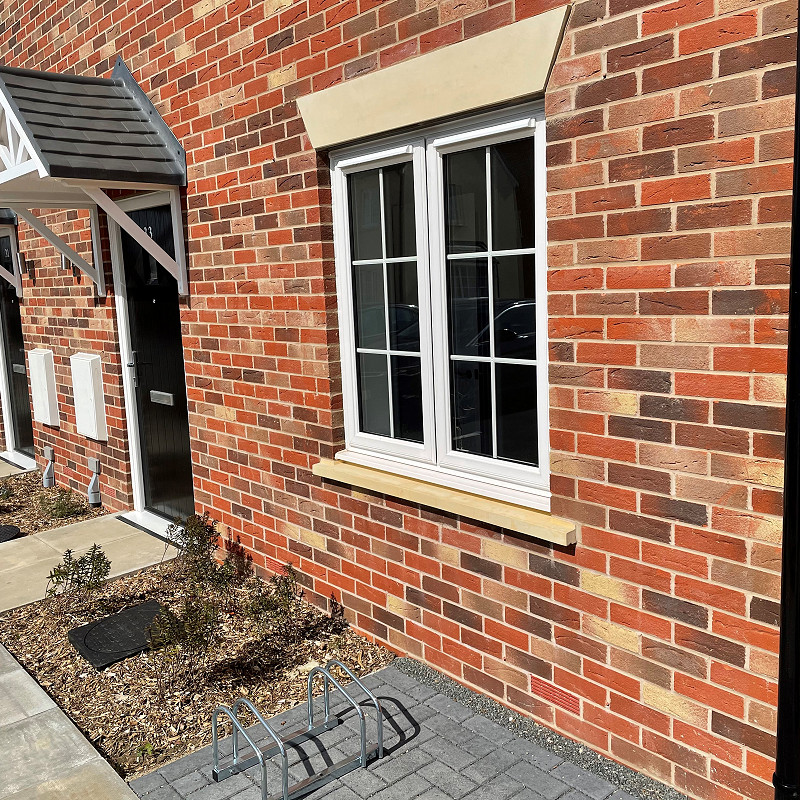 Maubray wirecut brick featuring cast stone heads.
