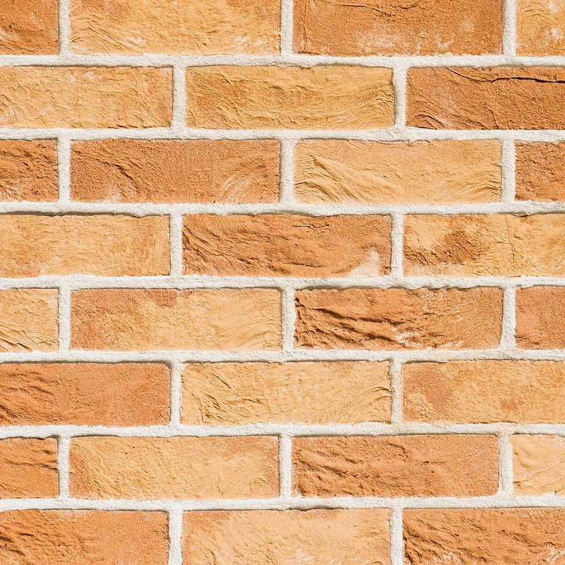 Close up of a yellow multi facing brick.