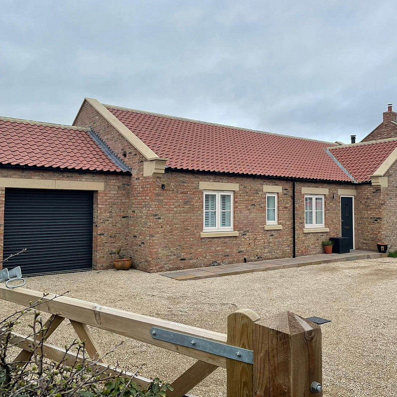 bungalow constructed in the middleton blend brick with cast stone features.