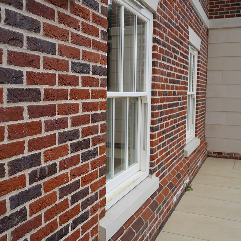 Close up of brickwork with cast stone heads and cills.