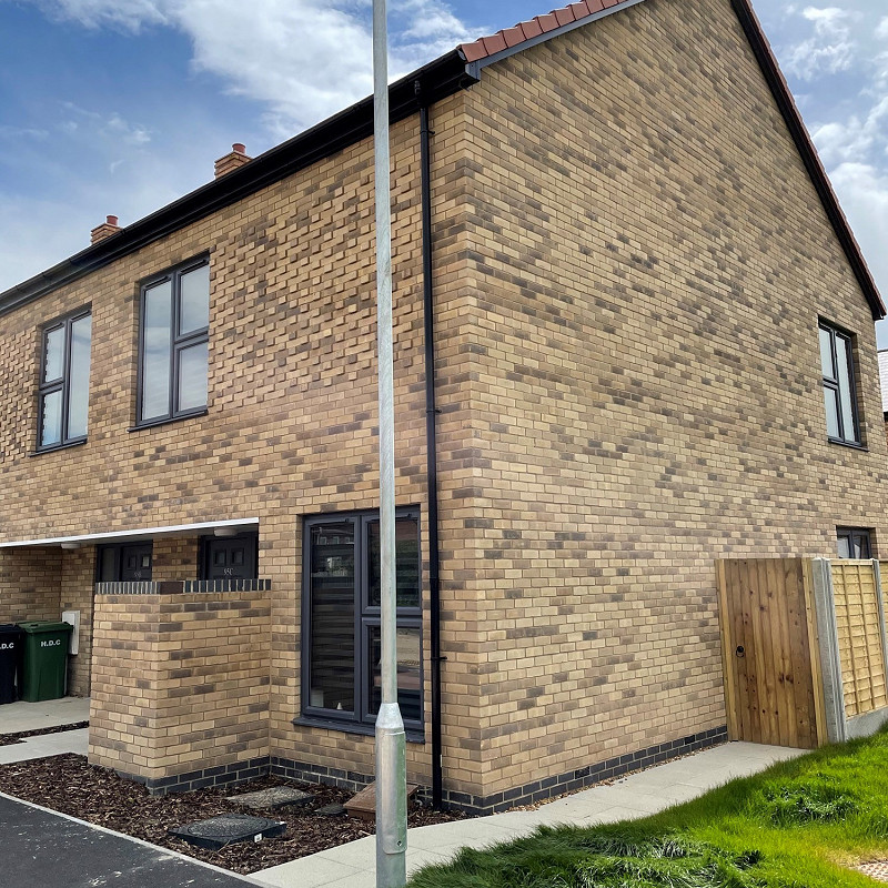 house with a buff brick facade.