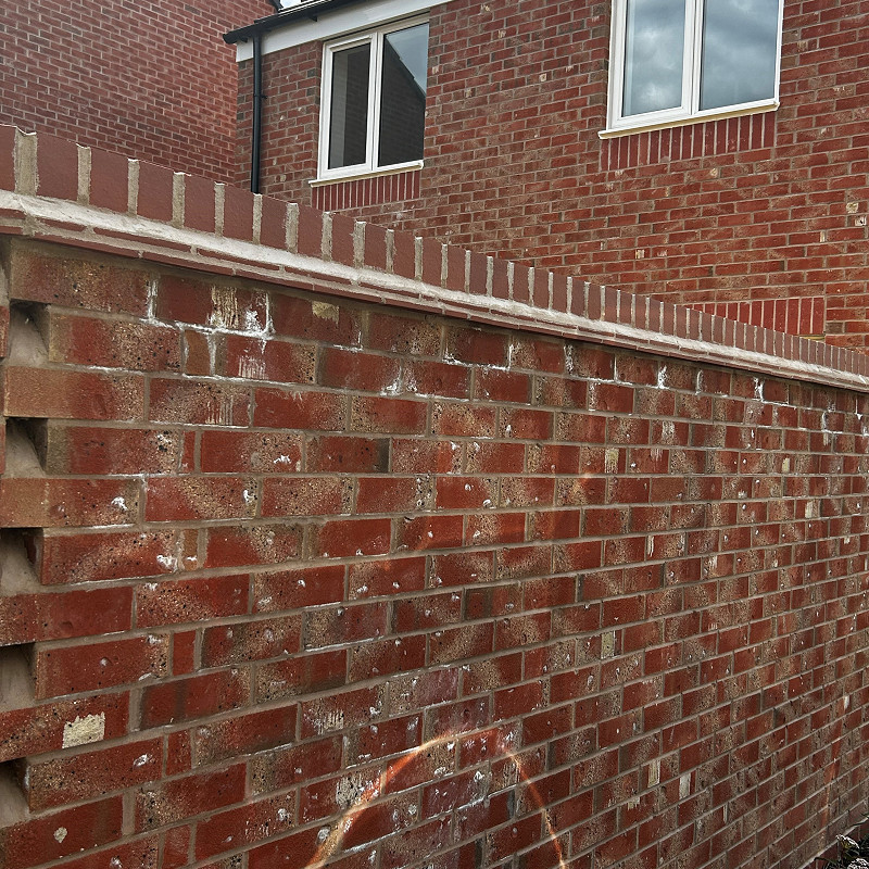 close up of a wirecut red mutli facing brick.