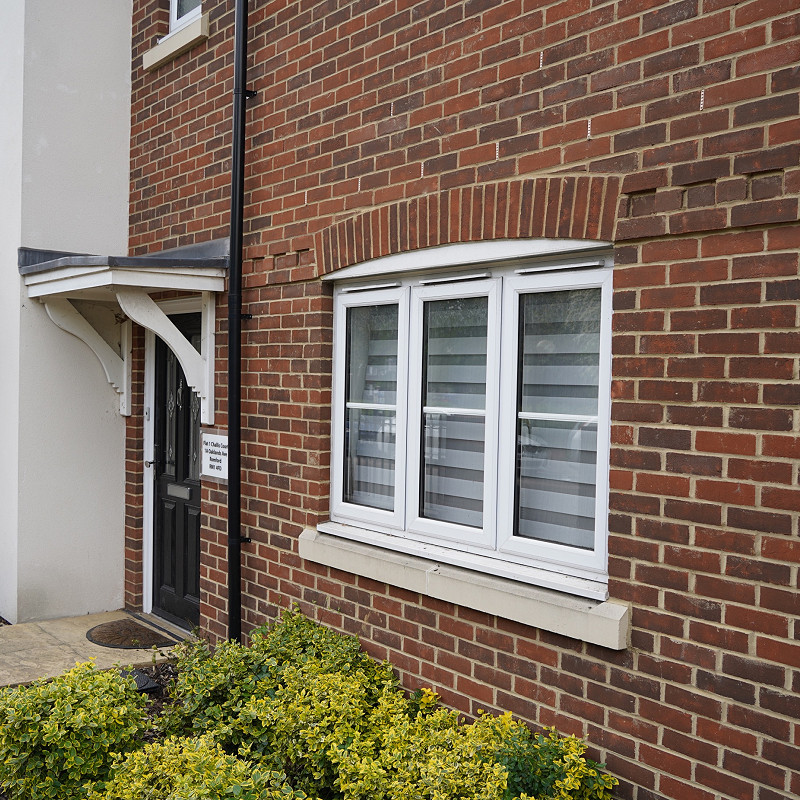 red brick wall with buff cast stone cill.
