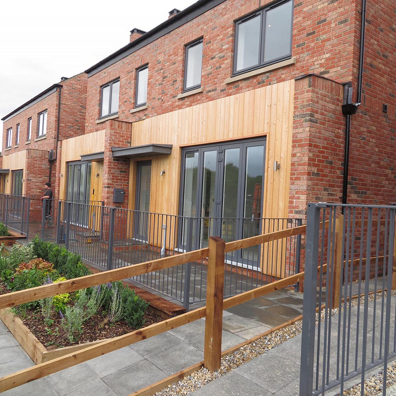 Newly built terraced houses constructed in a rustic wirecut brick.