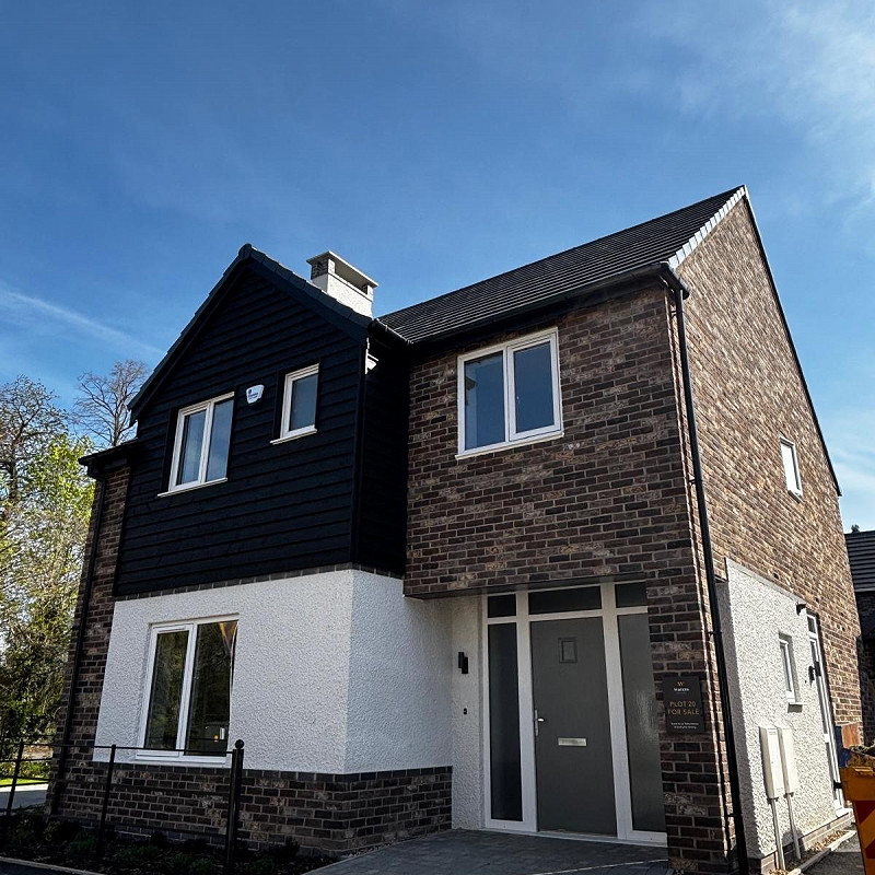 residential property constructed in a brown multi handmade textured brick.